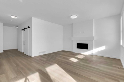 144 Copperhead Road Se, Calgary, AB - Indoor Photo Showing Living Room With Fireplace