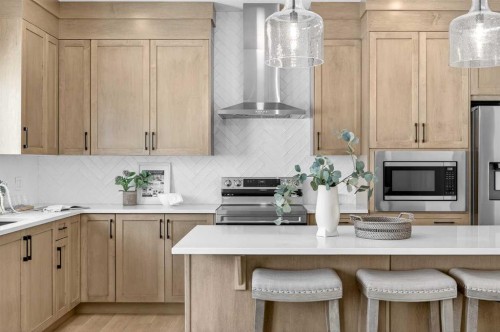 52 Fireside Common Sw, Cochrane, AB - Indoor Photo Showing Kitchen With Upgraded Kitchen