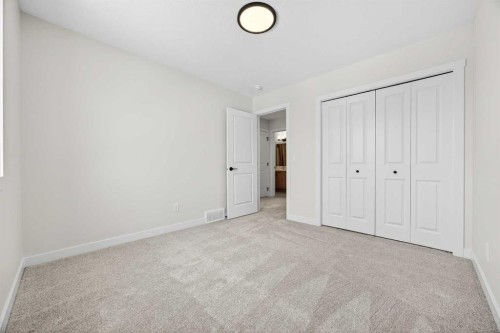 52 Fireside Common Sw, Cochrane, AB - Indoor Photo Showing Other Room