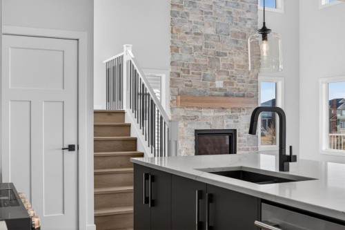 709 Dawson Place, Chestermere, AB - Indoor Photo Showing Kitchen With Fireplace With Double Sink