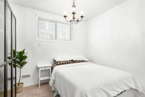 57 Riviera Crescent, Cochrane, AB - Indoor Photo Showing Bedroom