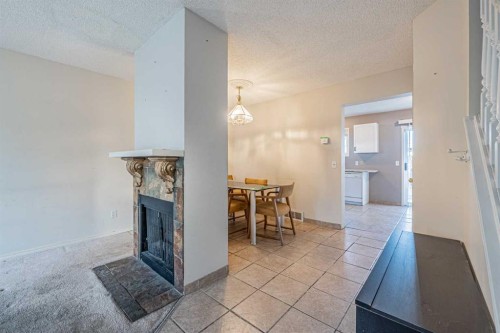68 Abbeydale Villas Ne, Calgary, AB - Indoor Photo Showing Other Room With Fireplace