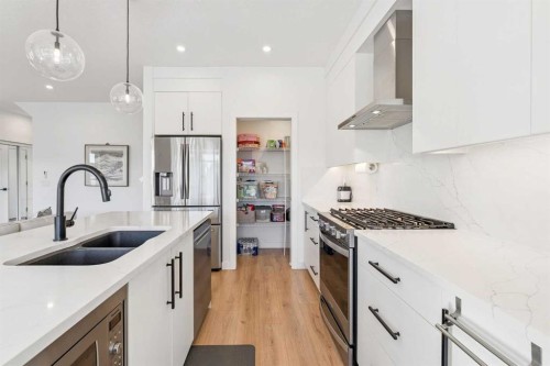 255-7820 Spring Willow Drive Sw, Calgary, AB - Indoor Photo Showing Kitchen With Stainless Steel Kitchen With Double Sink With Upgraded Kitchen