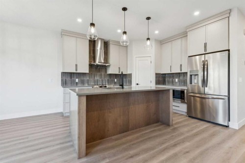 120 Quartz Crescent, Cochrane, AB - Indoor Photo Showing Kitchen With Upgraded Kitchen