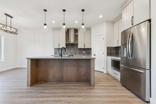 120 Quartz Crescent, Cochrane, AB - Indoor Photo Showing Kitchen With Upgraded Kitchen