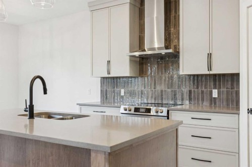 120 Quartz Crescent, Cochrane, AB - Indoor Photo Showing Kitchen With Double Sink With Upgraded Kitchen
