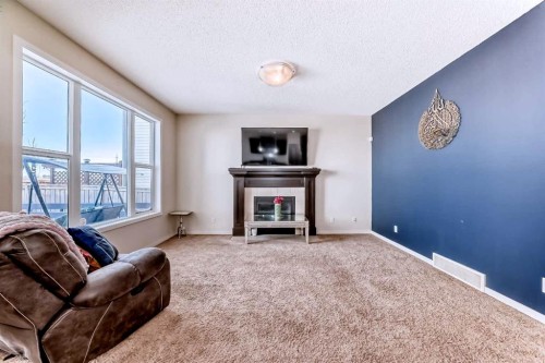 46 Cranford Gardens Se, Calgary, AB - Indoor Photo Showing Living Room With Fireplace