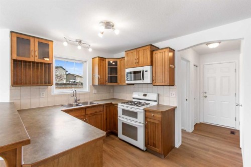 763 Stonehaven Drive, Carstairs, AB - Indoor Photo Showing Kitchen With Double Sink