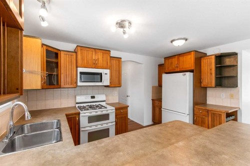 763 Stonehaven Drive, Carstairs, AB - Indoor Photo Showing Kitchen With Double Sink