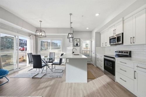 101-4250 Seton Drive Se, Calgary, AB - Indoor Photo Showing Kitchen With Upgraded Kitchen