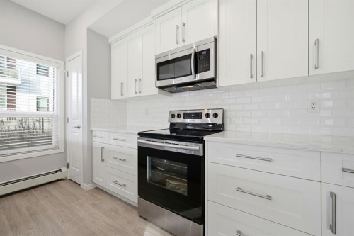 101-4250 Seton Drive Se, Calgary, AB - Indoor Photo Showing Kitchen With Upgraded Kitchen