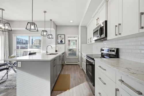 101-4250 Seton Drive Se, Calgary, AB - Indoor Photo Showing Kitchen With Upgraded Kitchen