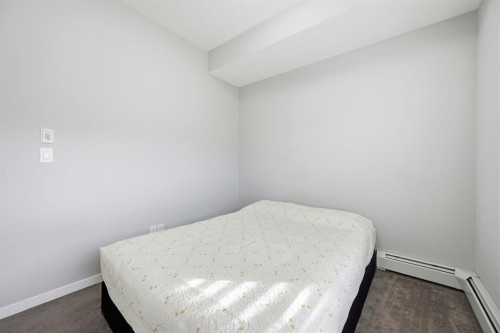 101-4250 Seton Drive Se, Calgary, AB - Indoor Photo Showing Bedroom