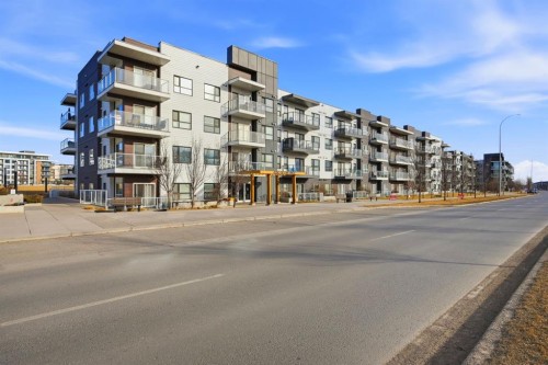 101-4250 Seton Drive Se, Calgary, AB - Outdoor With Balcony With Facade