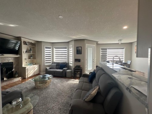 200 Hawkbury Close Nw, Calgary, AB - Indoor Photo Showing Living Room With Fireplace