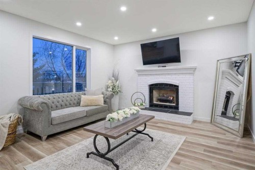 16 Sandringham Close Nw, Calgary, AB - Indoor Photo Showing Living Room With Fireplace