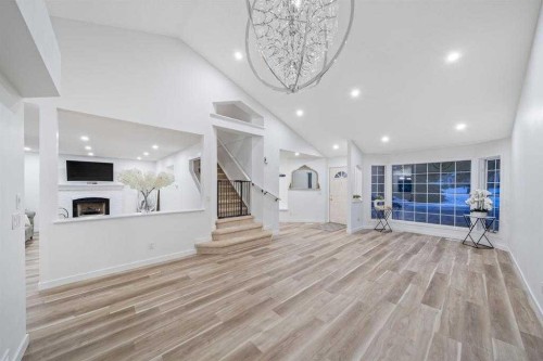 16 Sandringham Close Nw, Calgary, AB - Indoor Photo Showing Other Room With Fireplace