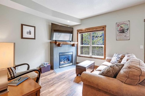 102-121 Kananaskis Way, Canmore, AB - Indoor Photo Showing Living Room With Fireplace