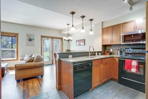 102-121 Kananaskis Way, Canmore, AB - Indoor Photo Showing Kitchen With Double Sink