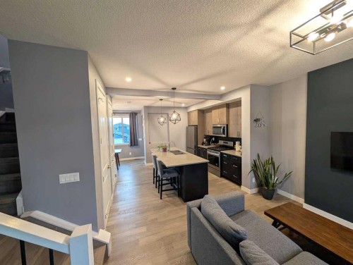 72 Sundown Crescent, Cochrane, AB - Indoor Photo Showing Other Room With Fireplace