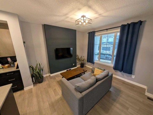 72 Sundown Crescent, Cochrane, AB - Indoor Photo Showing Living Room With Fireplace