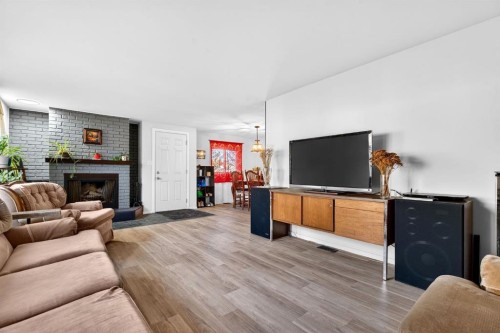 209 Sunset Boulevard Sw, Diamond Valley, AB - Indoor Photo Showing Living Room With Fireplace