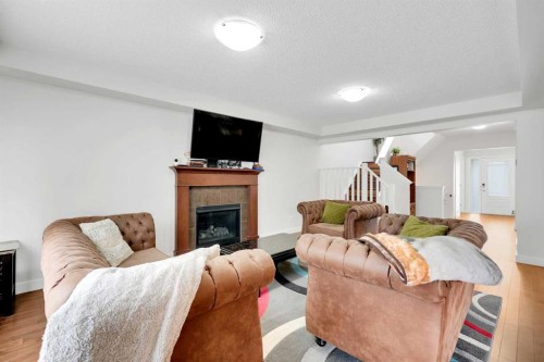 209 Windford Park Sw, Airdrie, AB - Indoor Photo Showing Living Room With Fireplace