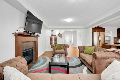 209 Windford Park Sw, Airdrie, AB - Indoor Photo Showing Living Room With Fireplace