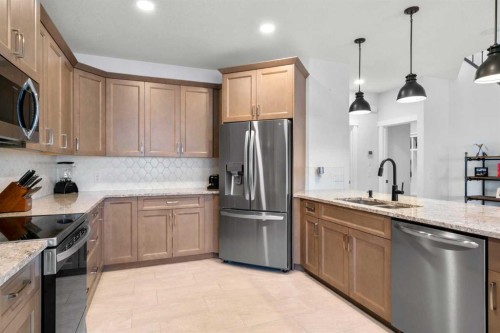 99 Ridge View Close, Cochrane, AB - Indoor Photo Showing Kitchen With Stainless Steel Kitchen With Double Sink With Upgraded Kitchen