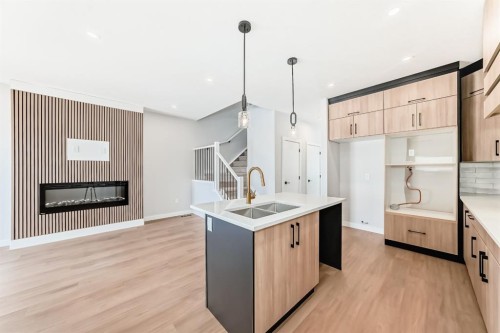 1947 Mccaskill Drive, Crossfield, AB - Indoor Photo Showing Kitchen With Fireplace With Double Sink