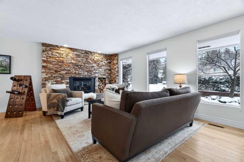 6913 Leaside Drive Sw, Calgary, AB - Indoor Photo Showing Living Room With Fireplace