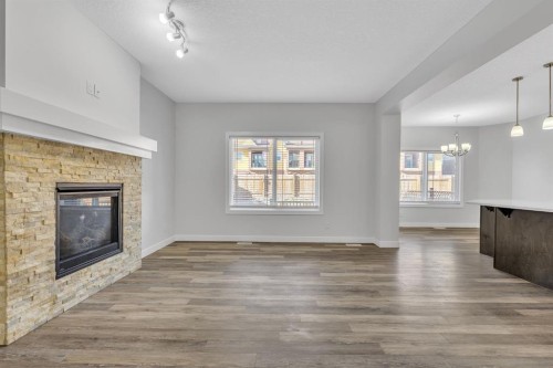 235 Kinniburgh Road, Chestermere, AB - Indoor Photo Showing Living Room With Fireplace