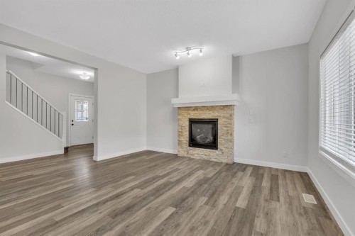 235 Kinniburgh Road, Chestermere, AB - Indoor Photo Showing Living Room With Fireplace
