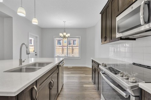 235 Kinniburgh Road, Chestermere, AB - Indoor Photo Showing Kitchen With Double Sink With Upgraded Kitchen