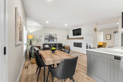 311 Chaparral Ravine View Se, Calgary, AB - Indoor Photo Showing Dining Room With Fireplace