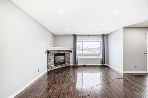 40 Cimarron Crescent, Okotoks, AB - Indoor Photo Showing Other Room With Fireplace