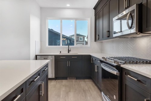 317 Midgrove Link Sw, Airdrie, AB - Indoor Photo Showing Kitchen With Upgraded Kitchen