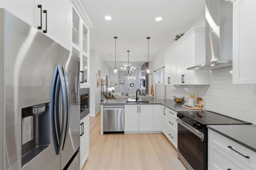 937 Reynolds Lane, Airdrie, AB - Indoor Photo Showing Kitchen With Upgraded Kitchen