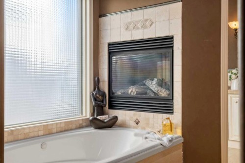 60 Woodpark Close Sw, Calgary, AB - Indoor Photo Showing Bathroom With Fireplace