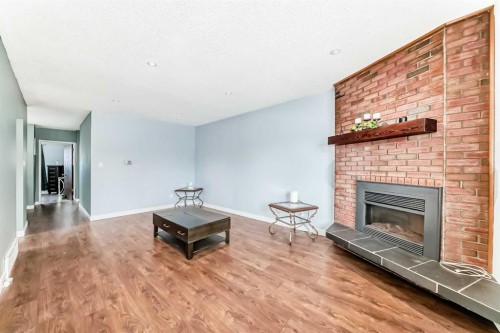 52A Queen Alexandra Close Se, Calgary, AB - Indoor Photo Showing Living Room With Fireplace