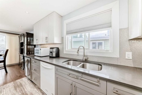 52A Queen Alexandra Close Se, Calgary, AB - Indoor Photo Showing Kitchen With Double Sink