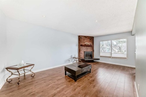 52A Queen Alexandra Close Se, Calgary, AB - Indoor Photo Showing Living Room With Fireplace