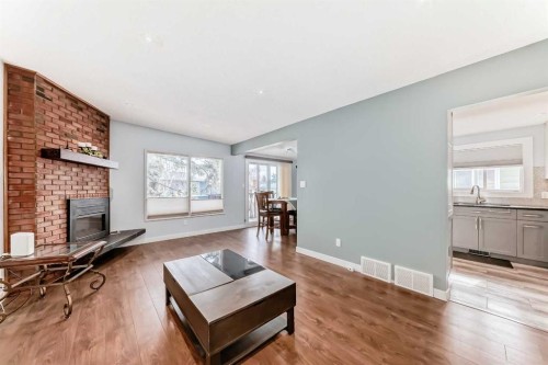 52A Queen Alexandra Close Se, Calgary, AB - Indoor Photo Showing Living Room With Fireplace
