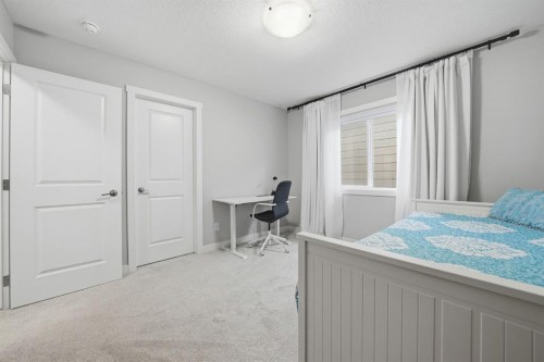 902 Bluerock Way Sw, Calgary, AB - Indoor Photo Showing Bedroom
