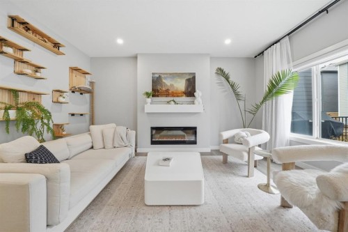 902 Bluerock Way Sw, Calgary, AB - Indoor Photo Showing Living Room With Fireplace