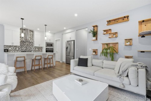902 Bluerock Way Sw, Calgary, AB - Indoor Photo Showing Living Room