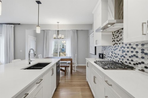 902 Bluerock Way Sw, Calgary, AB - Indoor Photo Showing Kitchen With Double Sink With Upgraded Kitchen