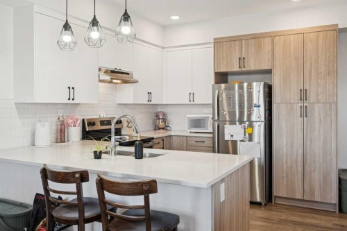 101-24 Rivercrest Drive, Cochrane, AB - Indoor Photo Showing Kitchen With Stainless Steel Kitchen With Upgraded Kitchen