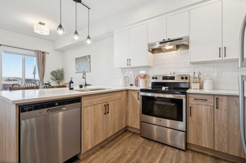 101-24 Rivercrest Drive, Cochrane, AB - Indoor Photo Showing Kitchen With Stainless Steel Kitchen With Upgraded Kitchen