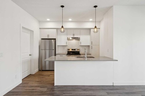 903-24 Rivercrest Drive, Cochrane, AB - Indoor Photo Showing Kitchen With Stainless Steel Kitchen With Double Sink With Upgraded Kitchen